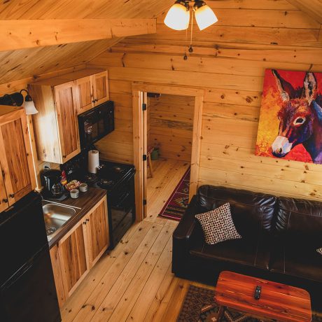 interior of cabin with furnishings and kitchen